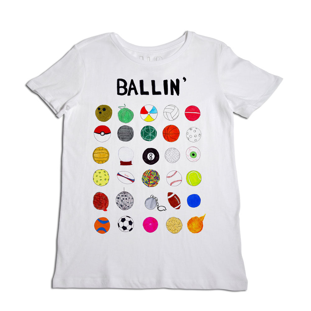 A white t-shirt with the word "ballin'" printed at the top and multiple colorful sports ball graphics below, including basketball, soccer, and baseball designs.