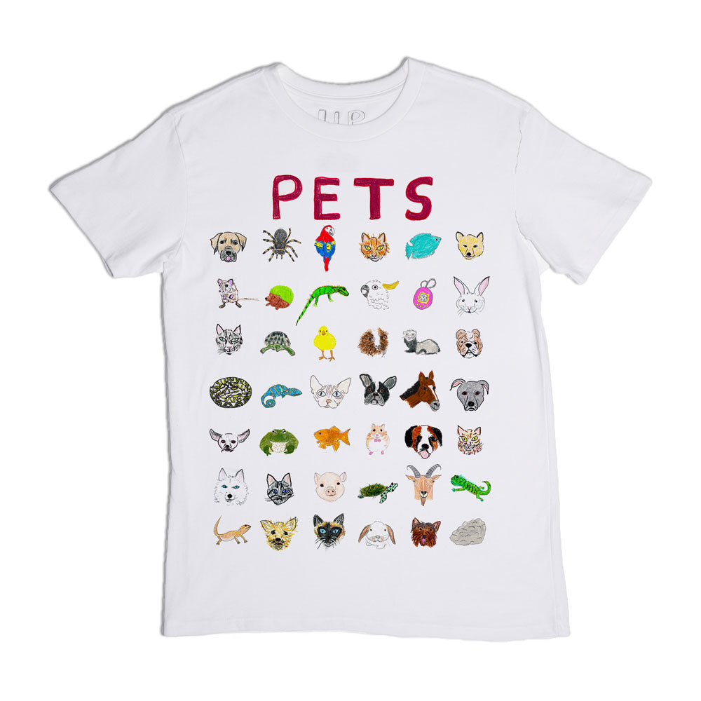 A white t-shirt with a colorful design featuring the word "pets" at the top and multiple illustrations of various pets including dogs, cats, birds, and reptiles below it.