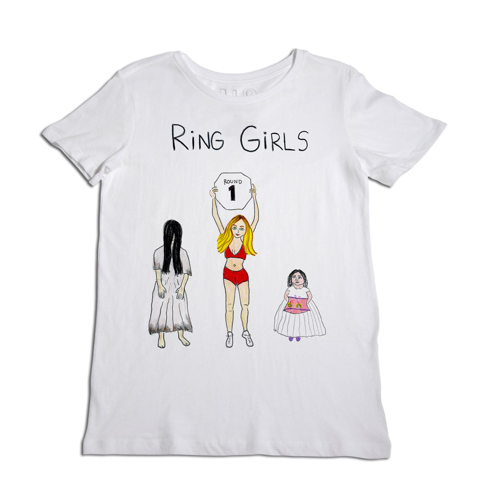 White t-shirt with a design featuring three cartoon-style female figures labeled "ring girls," one holding a sign that reads "round 1.