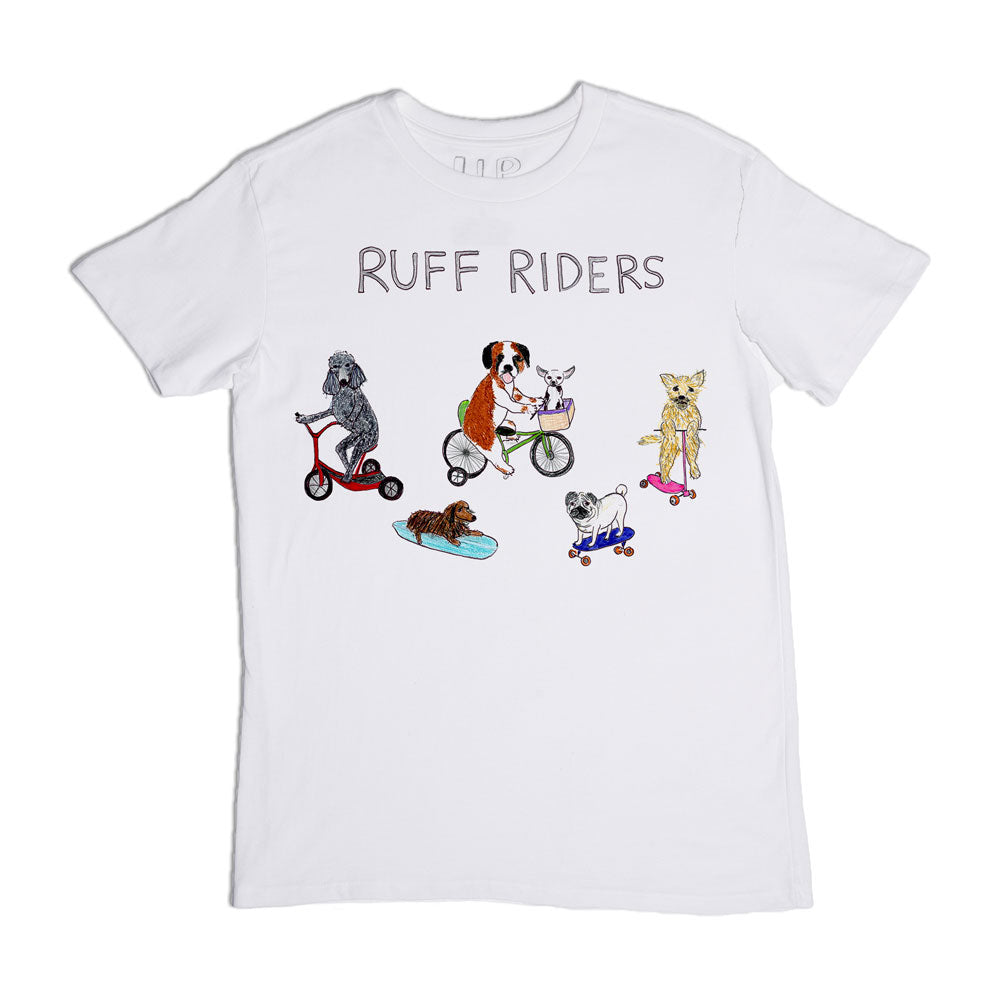 A white t-shirt with the phrase "ruff riders" featuring illustrations of four dogs: a grey dog on a scooter, a white and brown dog on a tricycle, a yellow dog on a bicycle, and a brown dog on a skateboard.