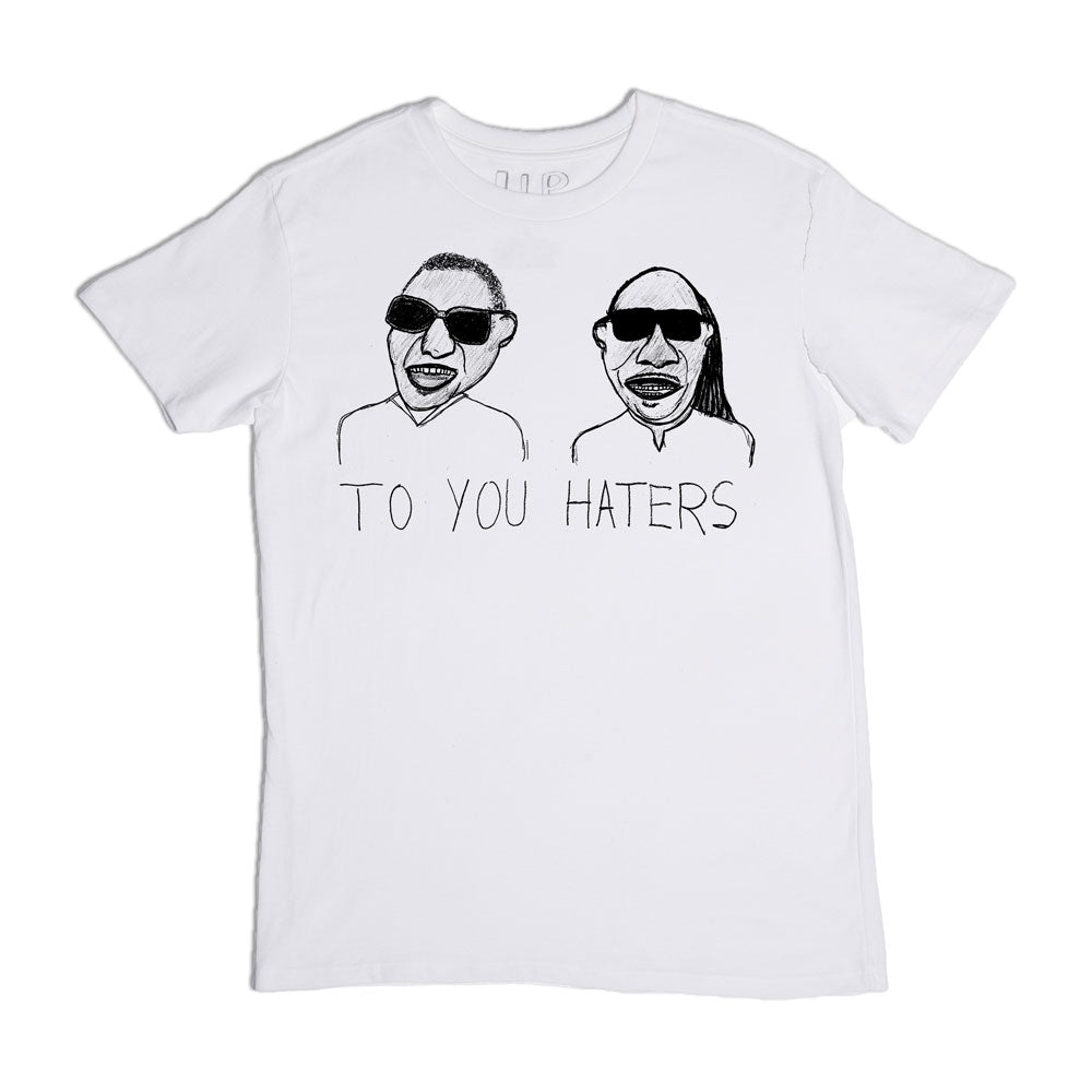 White t-shirt with a graphic print featuring two stylized faces wearing sunglasses and the phrase "to you haters" below them.
