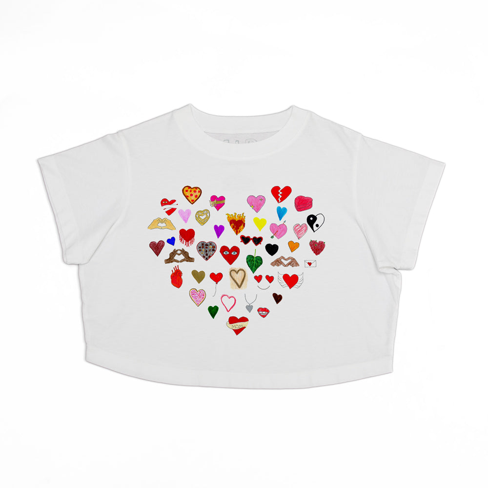 White t-shirt with a heart-shaped design made up of various colorful hearts, some patterned with animals and nature motifs, on a plain background.