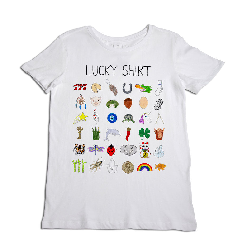 White t-shirt labeled "lucky shirt" displaying a collage of various symbols like a four-leaf clover, horseshoe, dice, and other items representing good luck.