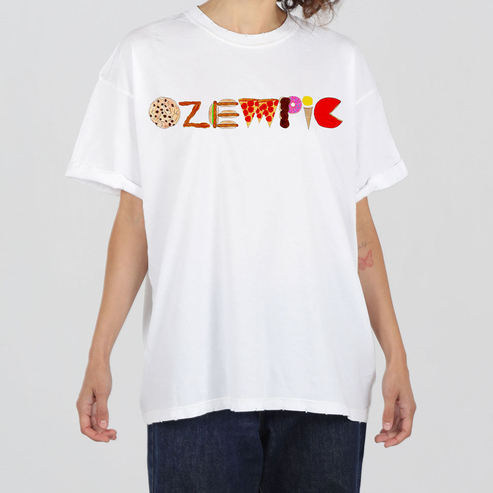 A person in a white t-shirt featuring a colorful, artistic logo that resembles the word "zlwmpic" with each letter designed with different textures and patterns.