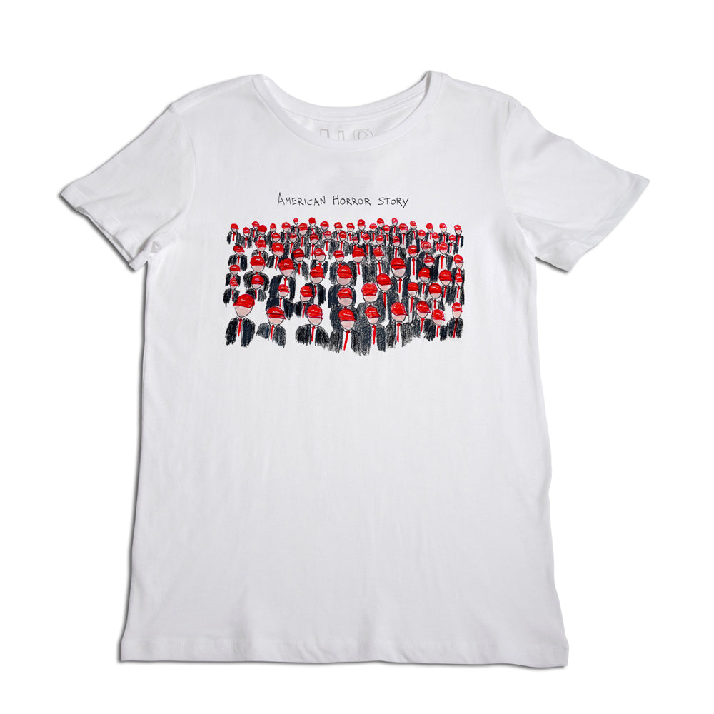 White t-shirt featuring a graphic print of multiple uniformed characters from the tv show "american horror story" arranged in multiple rows, with the show's title above the graphic.