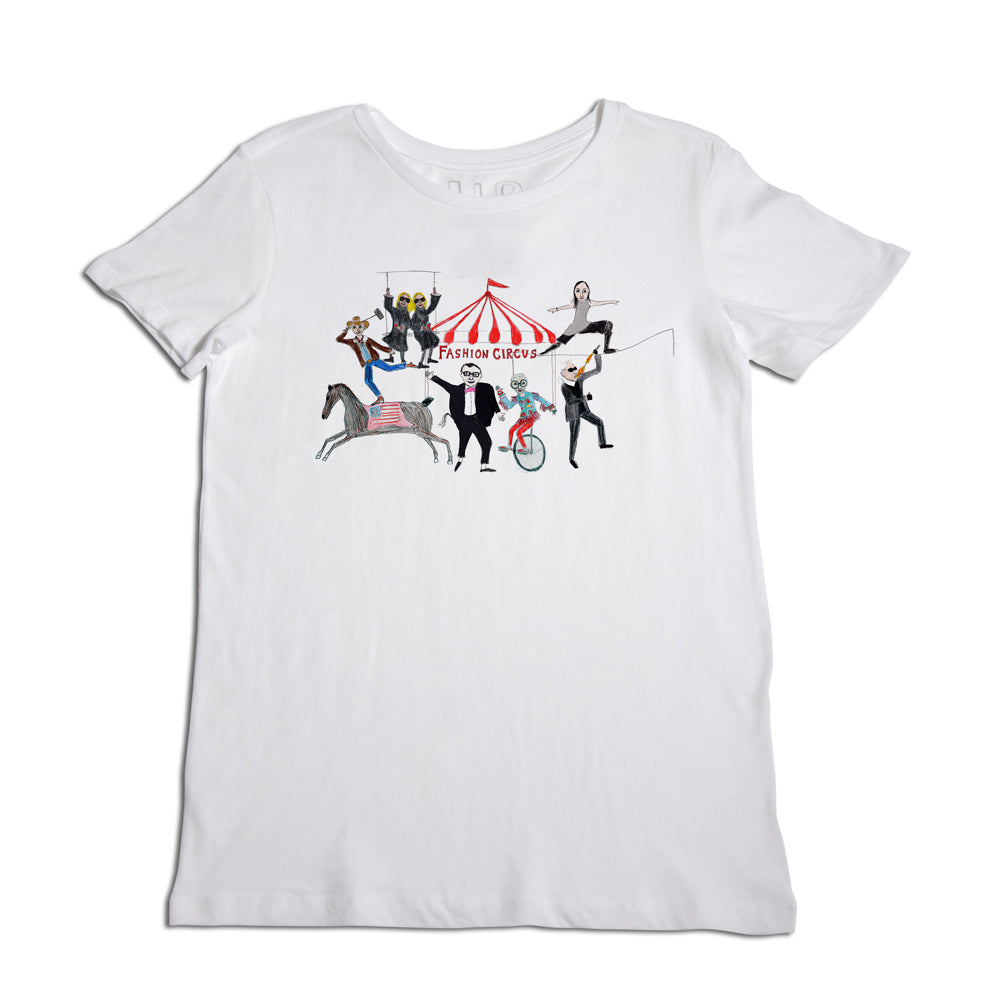 White t-shirt with a colorful "fashion circus" design featuring stylized performers including acrobats, a ringmaster, and animals performing tricks.