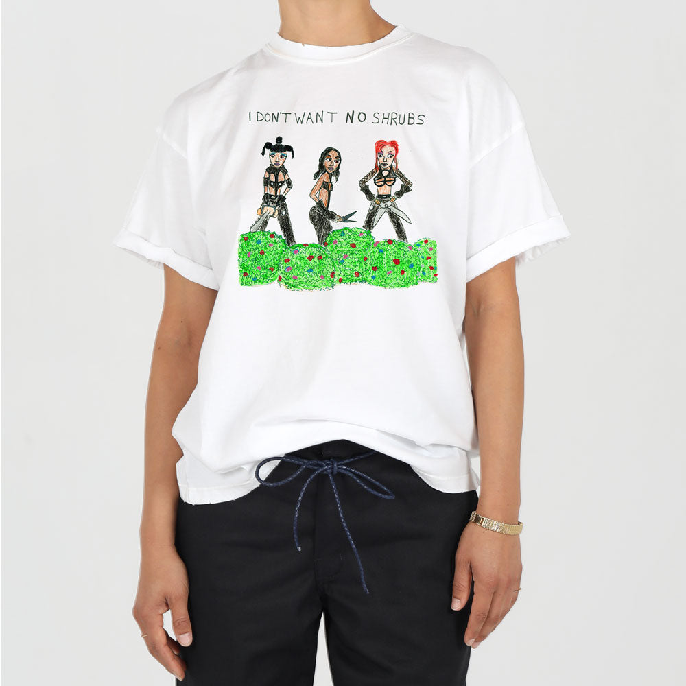 A person wearing a white t-shirt with a graphic of three women standing behind a green shrub and the text "i don't want no shrubs" printed above.
