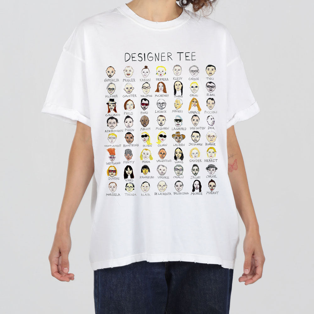 A person wearing a white t-shirt featuring a grid of cartoon illustrations labeled with various professions like "genius," "painter," and "koan.