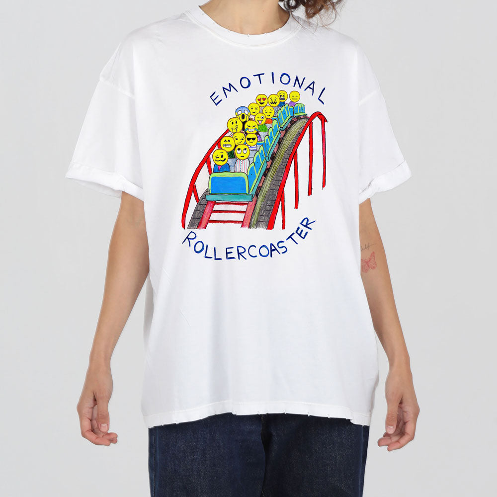 A person wearing a white t-shirt with a colorful design of a rollercoaster filled with yellow emoticon faces, and the words "emotional rollercoaster" arched above.