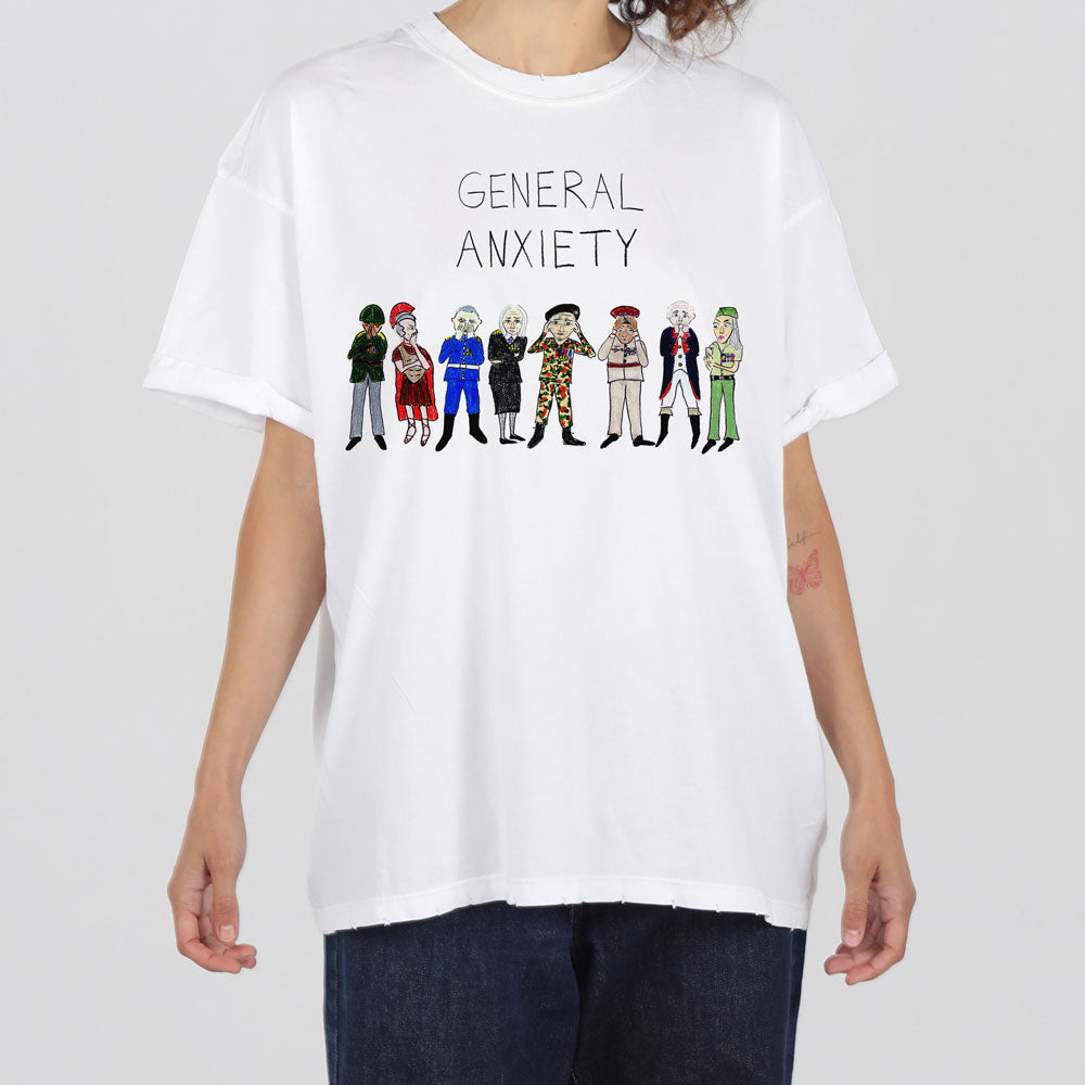 A person wearing a white t-shirt printed with a cartoon-style graphic showing a line-up of diverse, colorful characters under the text "general anxiety.