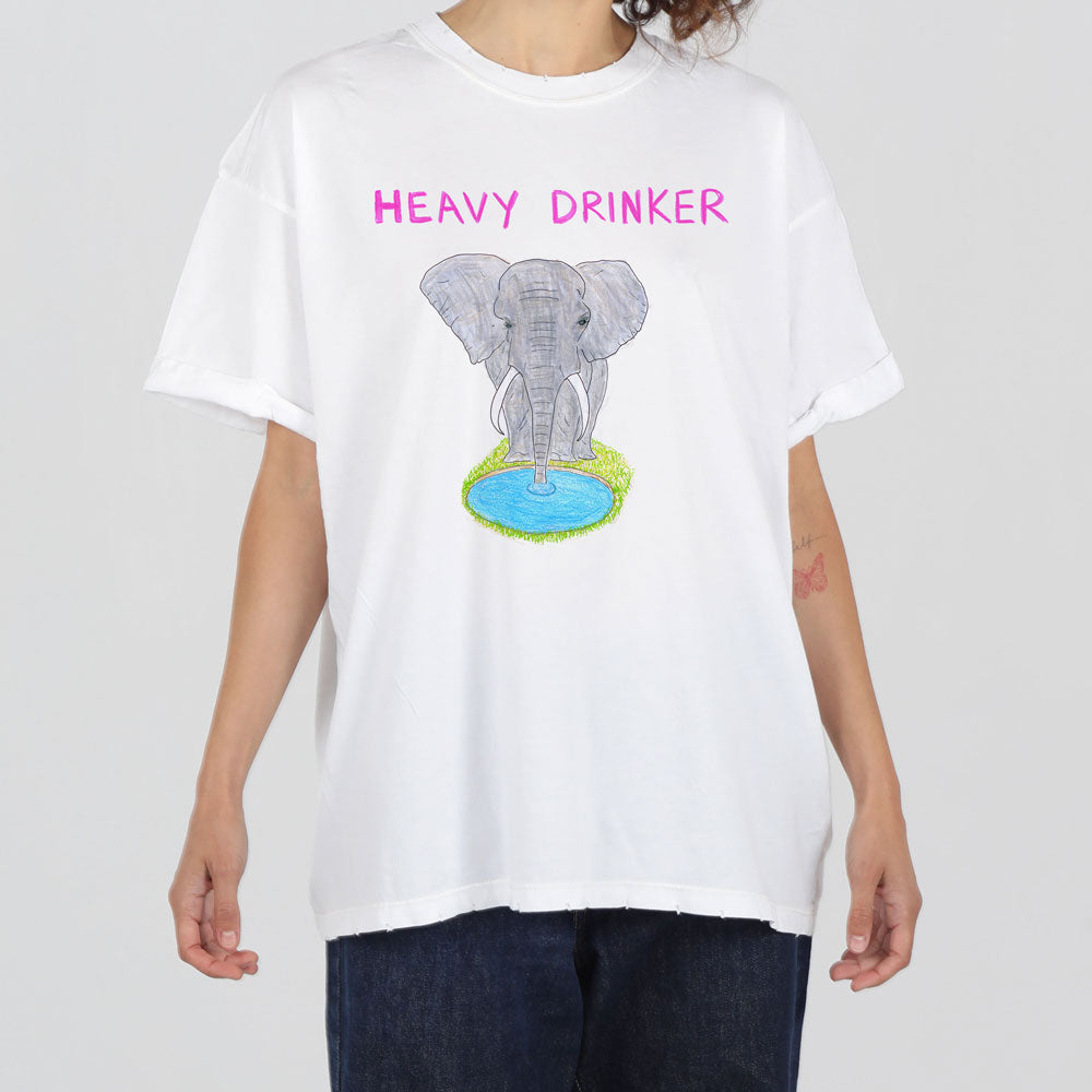A person in a white t-shirt with the phrase "heavy drinker" above an illustration of an elephant standing on a globe, holding a cocktail.