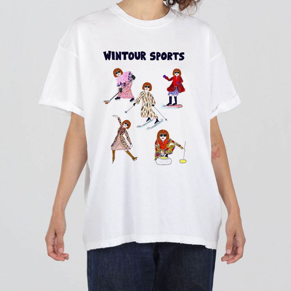 A person wearing a white t-shirt featuring colorful cartoon illustrations of fashionably dressed women engaging in various sports, with the text "wintour sports" above the images.