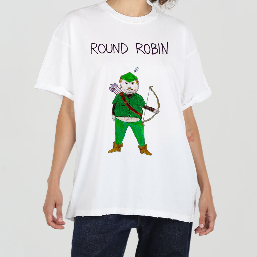 A person wearing a white t-shirt with a graphic of a whimsical elf character, dressed in green and holding a bow and arrow, labeled "round robin".