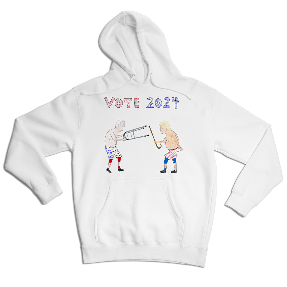 White hoodie with a playful "vote 2024" graphic featuring two animated figures in a tug-of-war over a large pencil, set against a clean background.