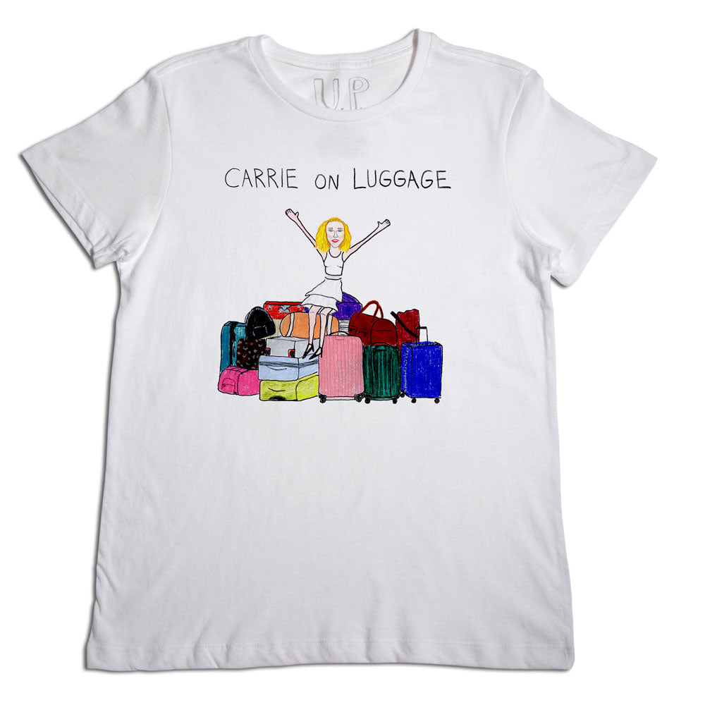 White t-shirt featuring a colorful illustration of a woman sitting on a stack of luggage with the text "carrie on luggage" above.