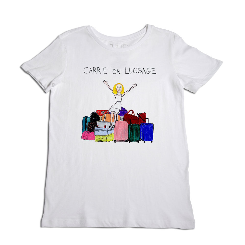 White t-shirt featuring a colorful print of a blonde woman sitting on top of a pile of various colorful suitcases, with the caption "carrie on luggage" above.