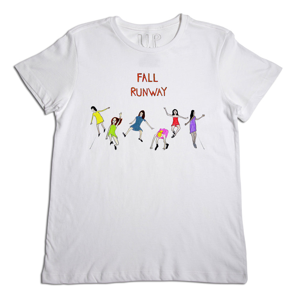 A white t-shirt with the text "fall runway" and an illustration of seven diverse figures in various colorful outfits, seemingly striding energetically across the chest area.