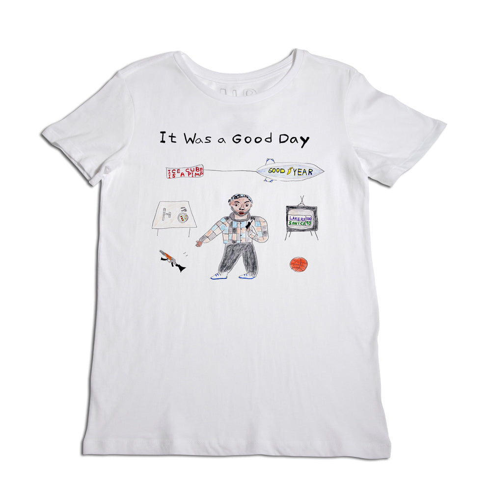 White t-shirt with a design featuring a drawing of a man in casual attire surrounded by a basketball, a blimp, dice, and a few illustrated elements. above is text that says "it was a good day.