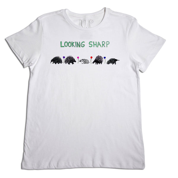 White t-shirt with the phrase "looking sharp" printed in green above a row of five hedgehog illustrations, each in different colors and shapes.