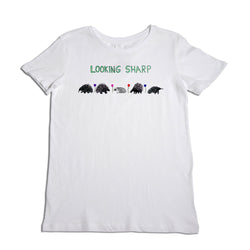 White t-shirt with the phrase "looking sharp" printed above an illustrated lineup of five hedgehogs, each in contrasting colors, against a plain background.