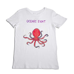 A white t-shirt featuring a vibrant illustration of a red octopus with the words "ocean's eight" printed in purple above it. the t-shirt is displayed against a white background.