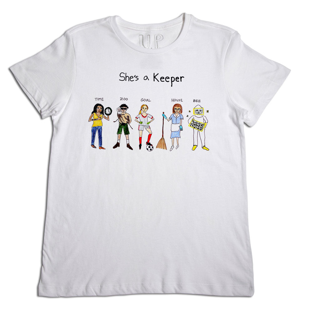 A white t-shirt with an illustration featuring six diverse women, each representing different puns like "time keeper" and "goal keeper," and the phrase "she's a keeper" at the top.
