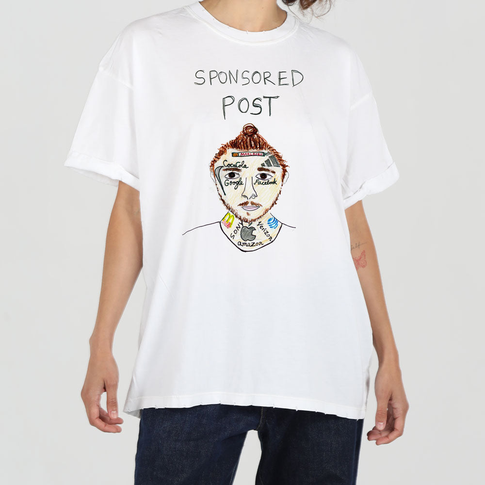 A person in a plain white t-shirt with the words "sponsored post" above a colorful, abstract face drawing, standing against a neutral background.