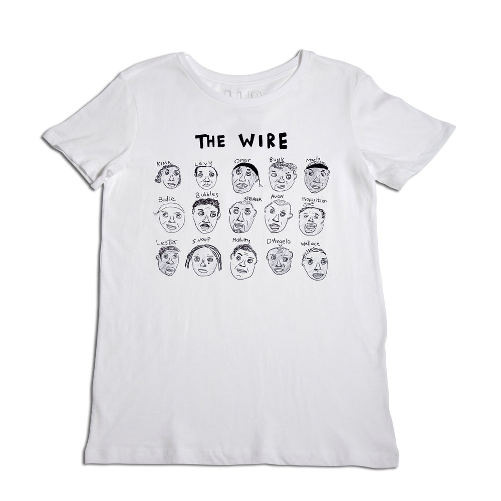 A white t-shirt featuring a black printed design with the title "the wire" and illustrated faces of various characters from the show, each labeled with their names.