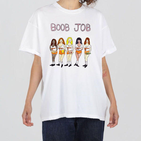 A person wearing a white t-shirt with a graphic print depicting six stylized female figures and the phrase "boob job" above them.