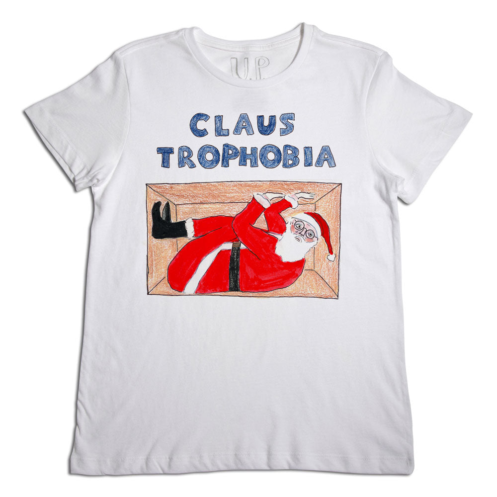A white t-shirt with a humorous graphic of santa claus looking squeezed and uncomfortable in a chimney, titled "claus-trophobia." the design uses bright colors and a playful font.