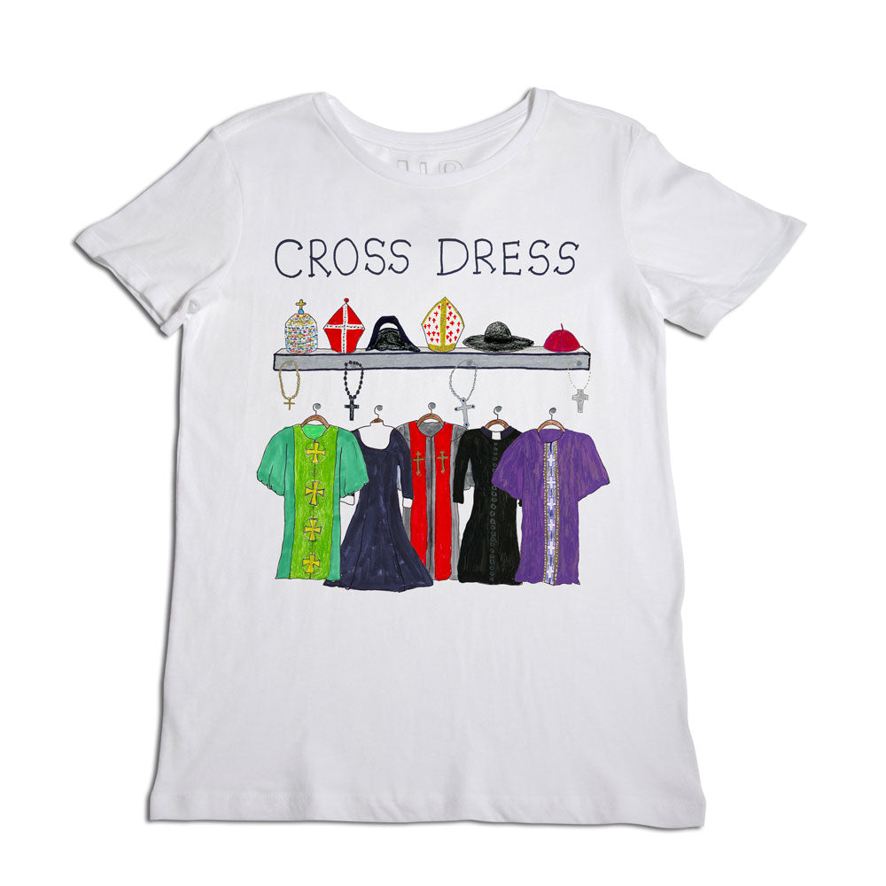 A white t-shirt featuring a colorful design with the words "cross dress" at the top. below the text, various dresses hang from a rack, each adorned with different religious symbols.