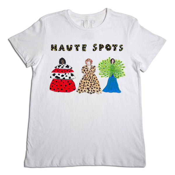 White t-shirt with colorful applique designs of three stylized, fashionable women in diverse dresses, labeled "haute spots" across the top.