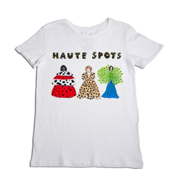 White t-shirt featuring the phrase "haute spots" with illustrations of three stylish dogs in fashionable dresses, each with a unique pattern and color.