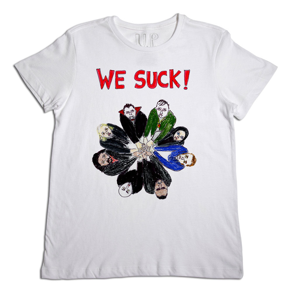 White t-shirt with the phrase "we suck!" in red letters and a graphic of various cartoon faces arranged in a circular pattern, resembling a flower. .